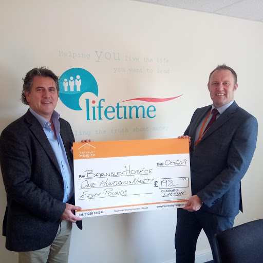 Lifetime director William Bottomley hands over hospice referral scheme cheque to Simon Atkinson of Barnsley Hospice.