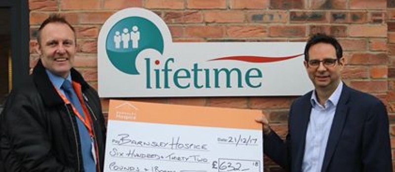 Hospice fundraiser Simon all smiles after receiving Lifetime referral scheme cheque